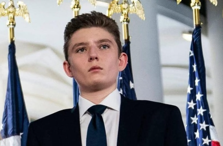 Image ALT Text: Barron Trump with parents at public event